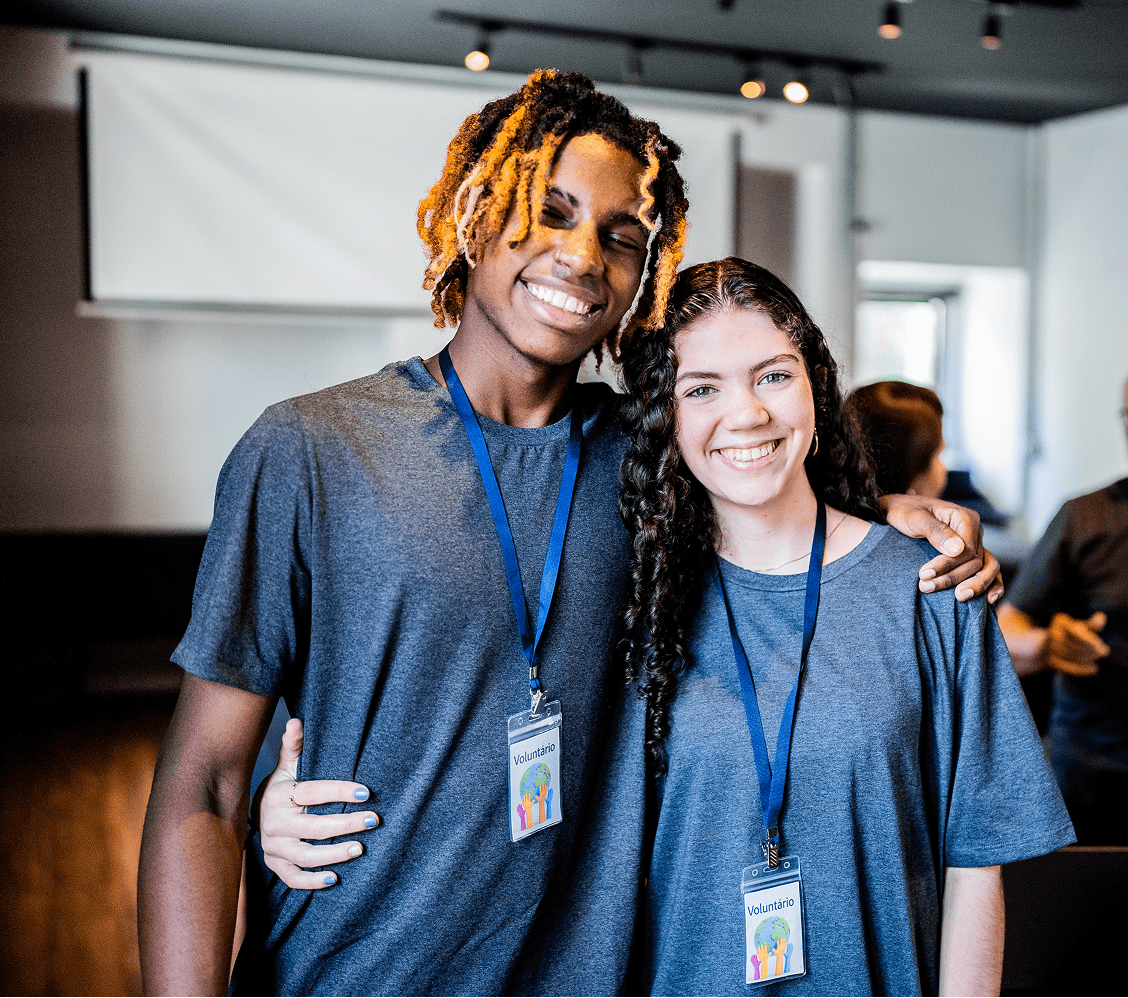 Two friends smiling with conference badges